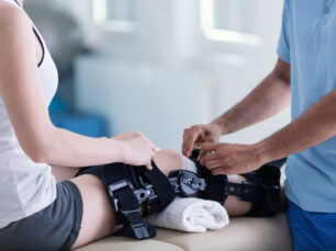 Close-up on person with stiffener on broken leg during rehabilit